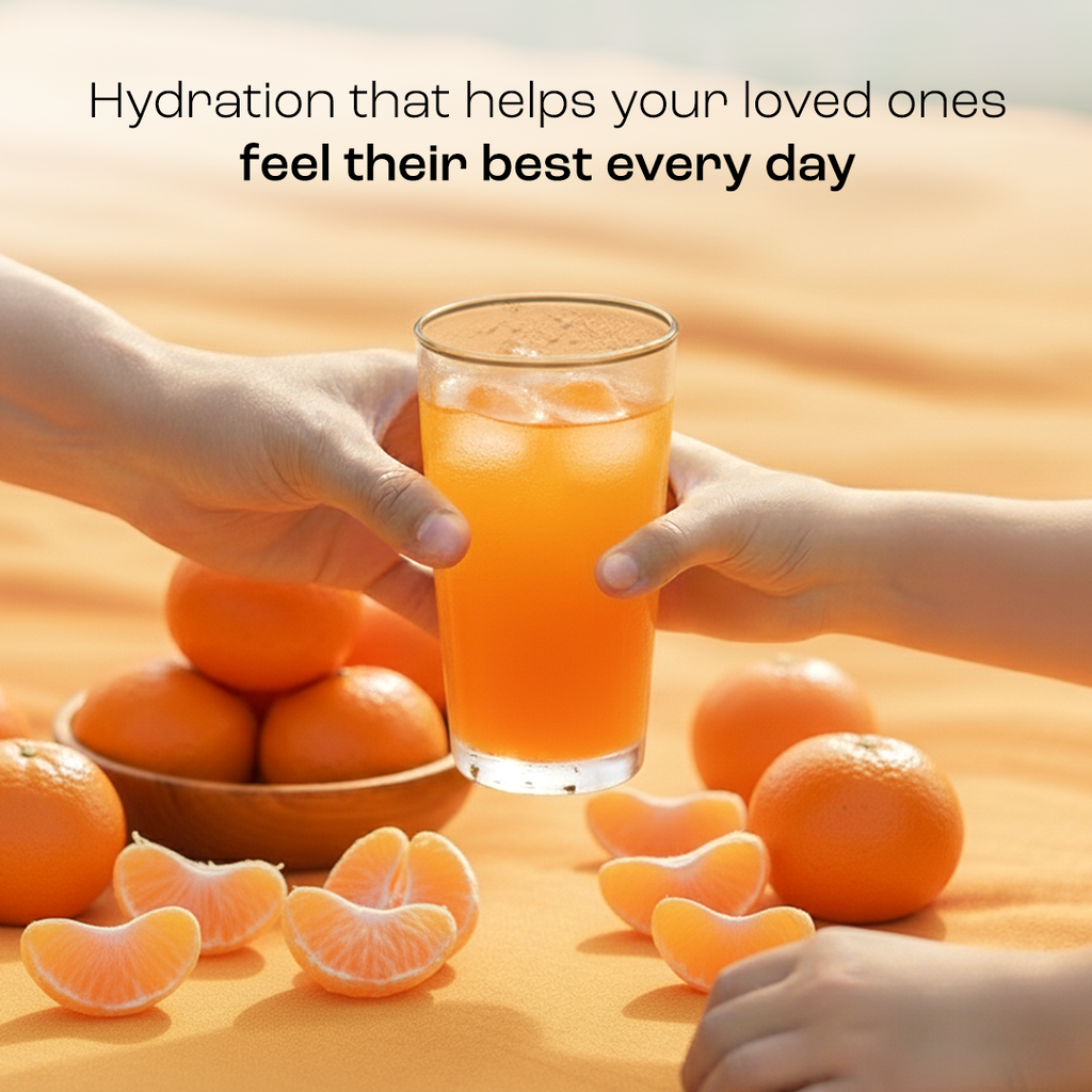 Orange electrolyte drink in a glass with orange fruit beside it