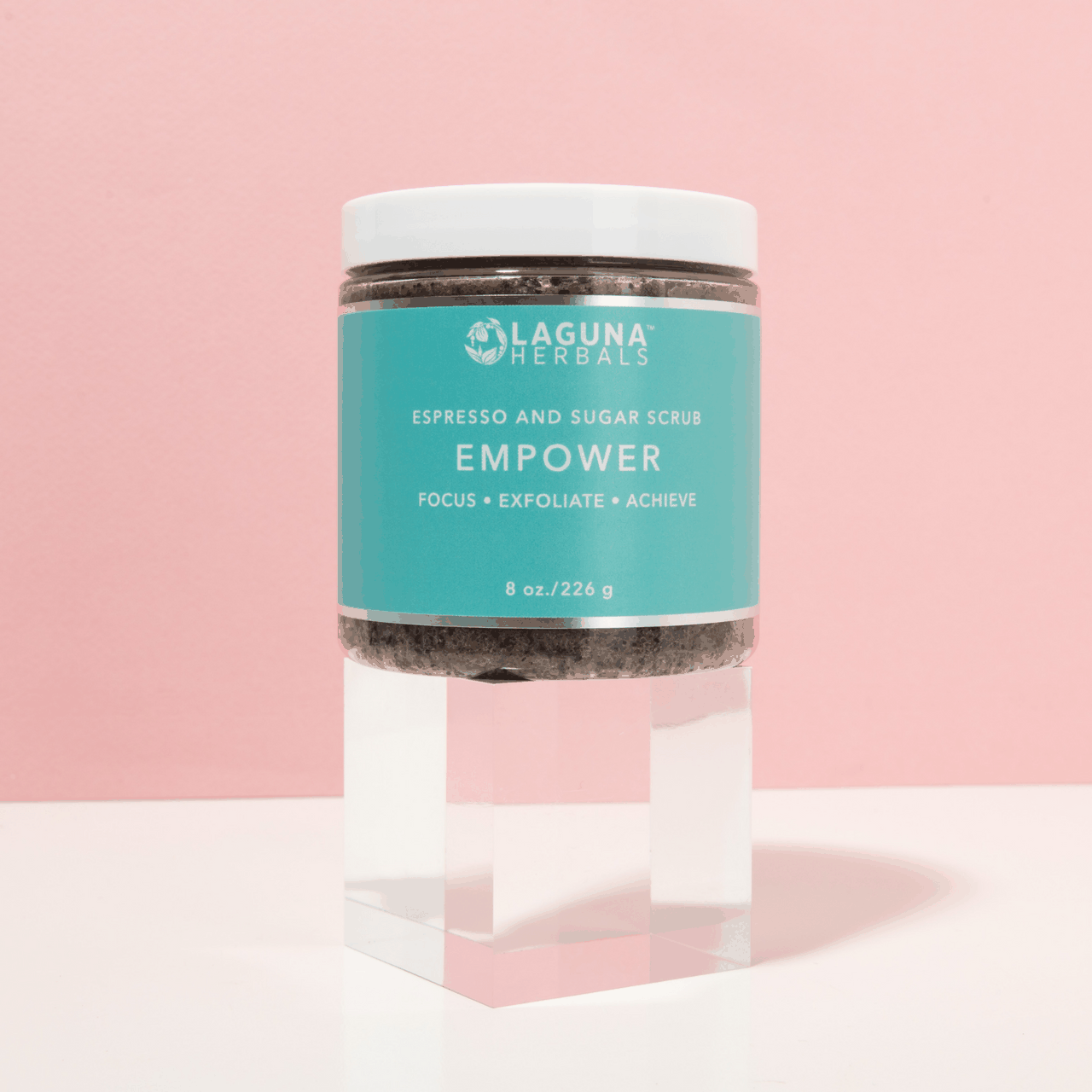 Empower body scrub jar, turquoise label with espresso and sugar name, dark scrub contents