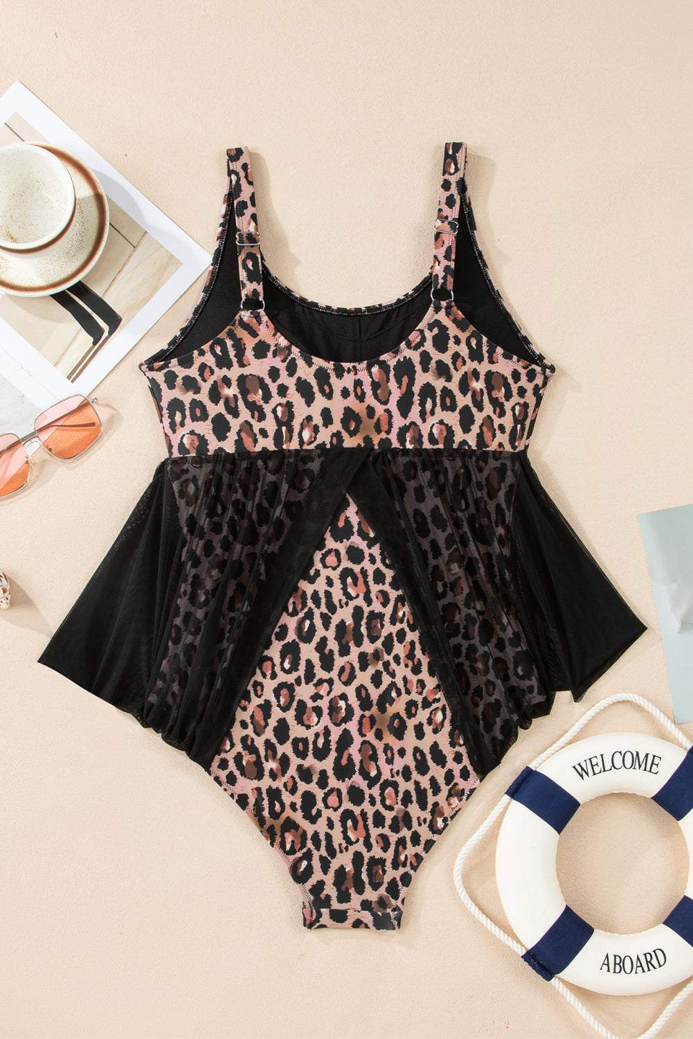 Flat lay: leopard-print one-piece with black mesh skirt panels and V-neck