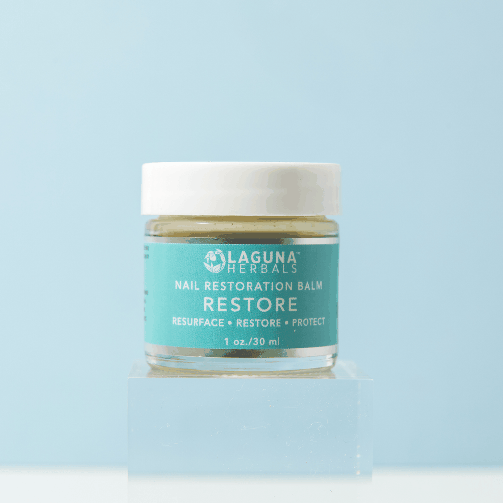 Restore nail restoration balm jar with white lid and teal label