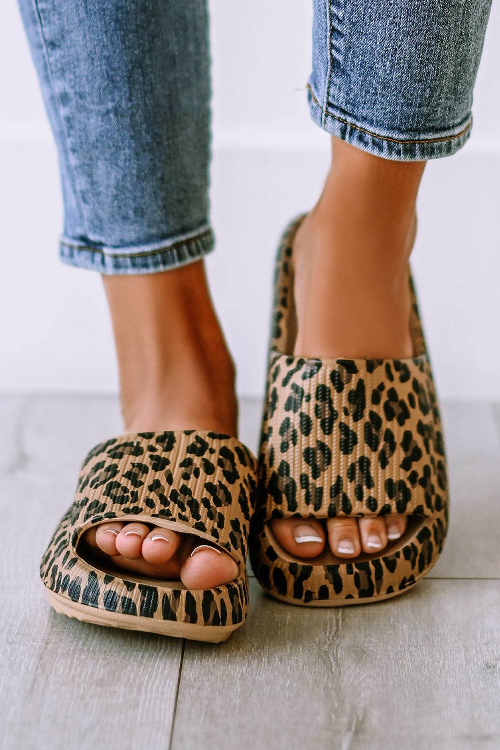Pair of leopard print slip-on slippers with thick sole, front view