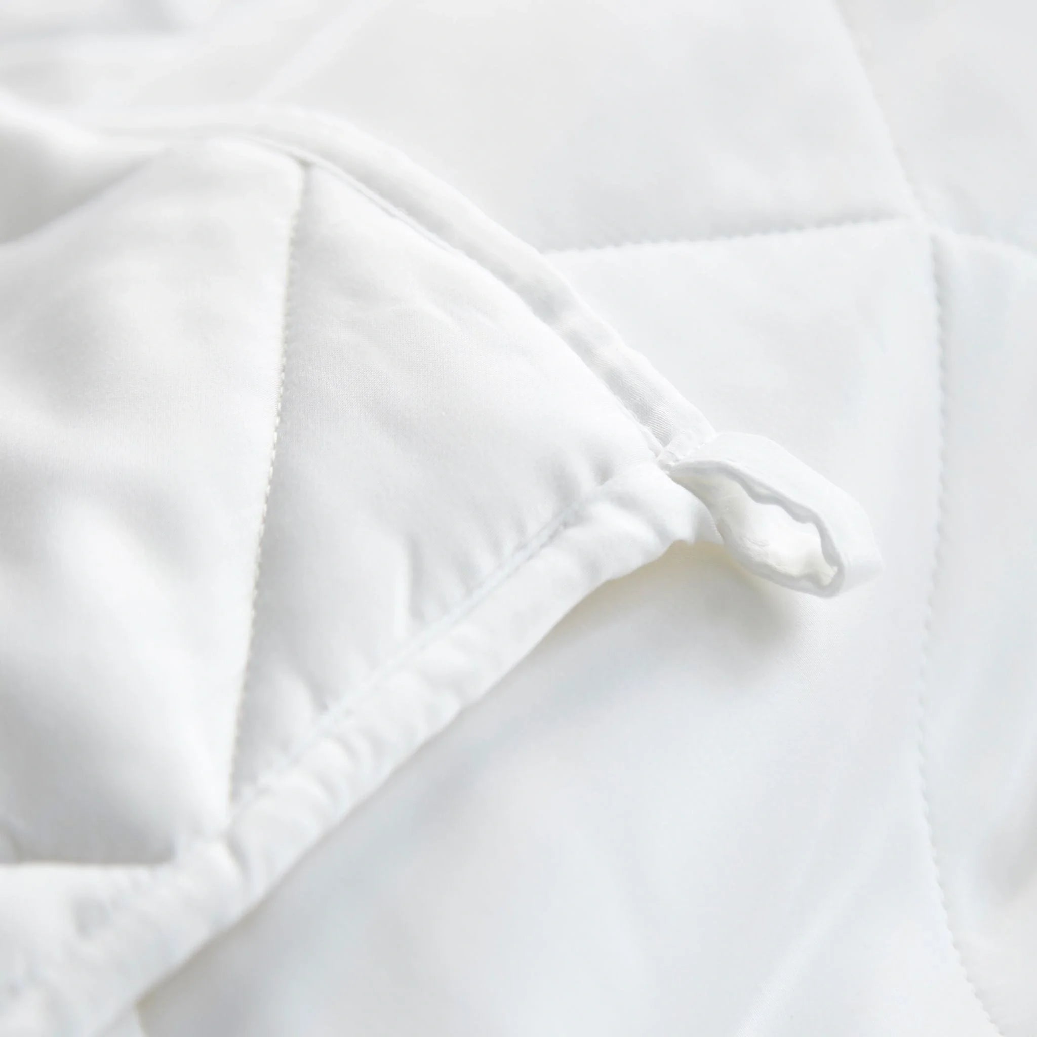 White duvet corner with box stitching and fabric fold seam