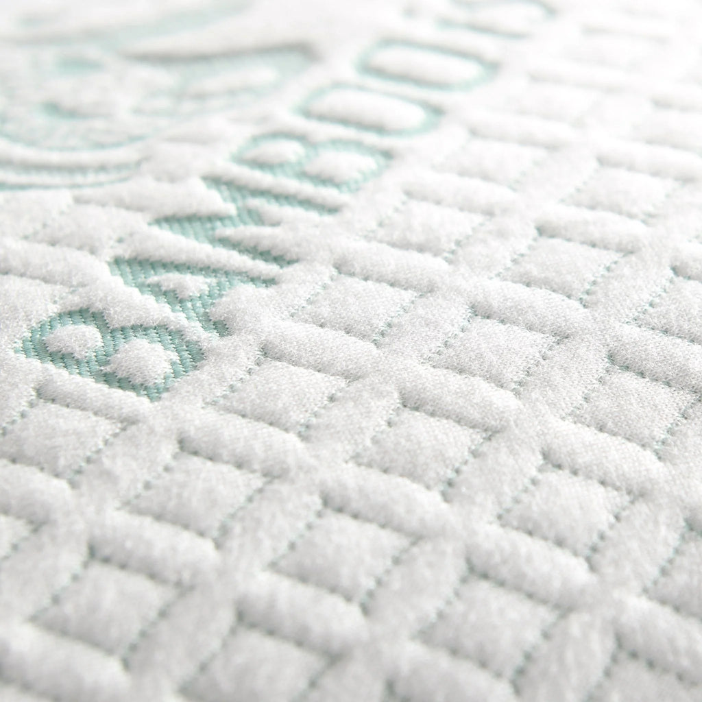 Bamboo cooling pillow fabric close-up with raised white texture and mint diamond shapes