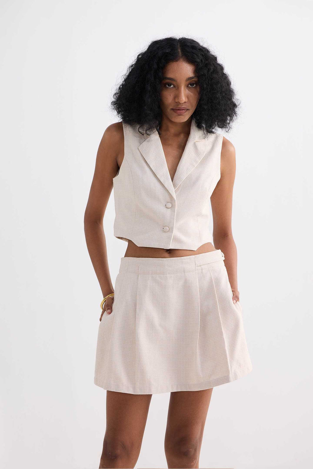 Cream cotton tweed skort with centered front seam and roomy pleated fit