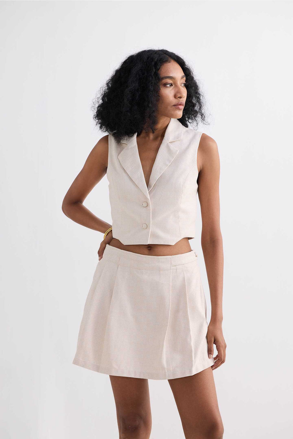 Cream cotton tweed skort in A-line silhouette with front pleating
