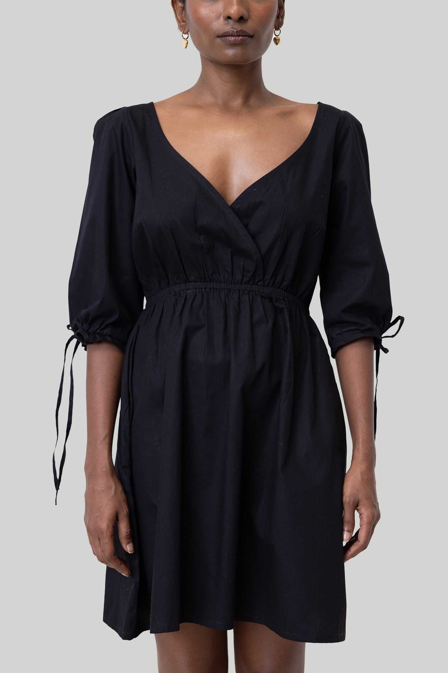 Black short dress with puffed elbow sleeves and ruched empire waist, V-neck