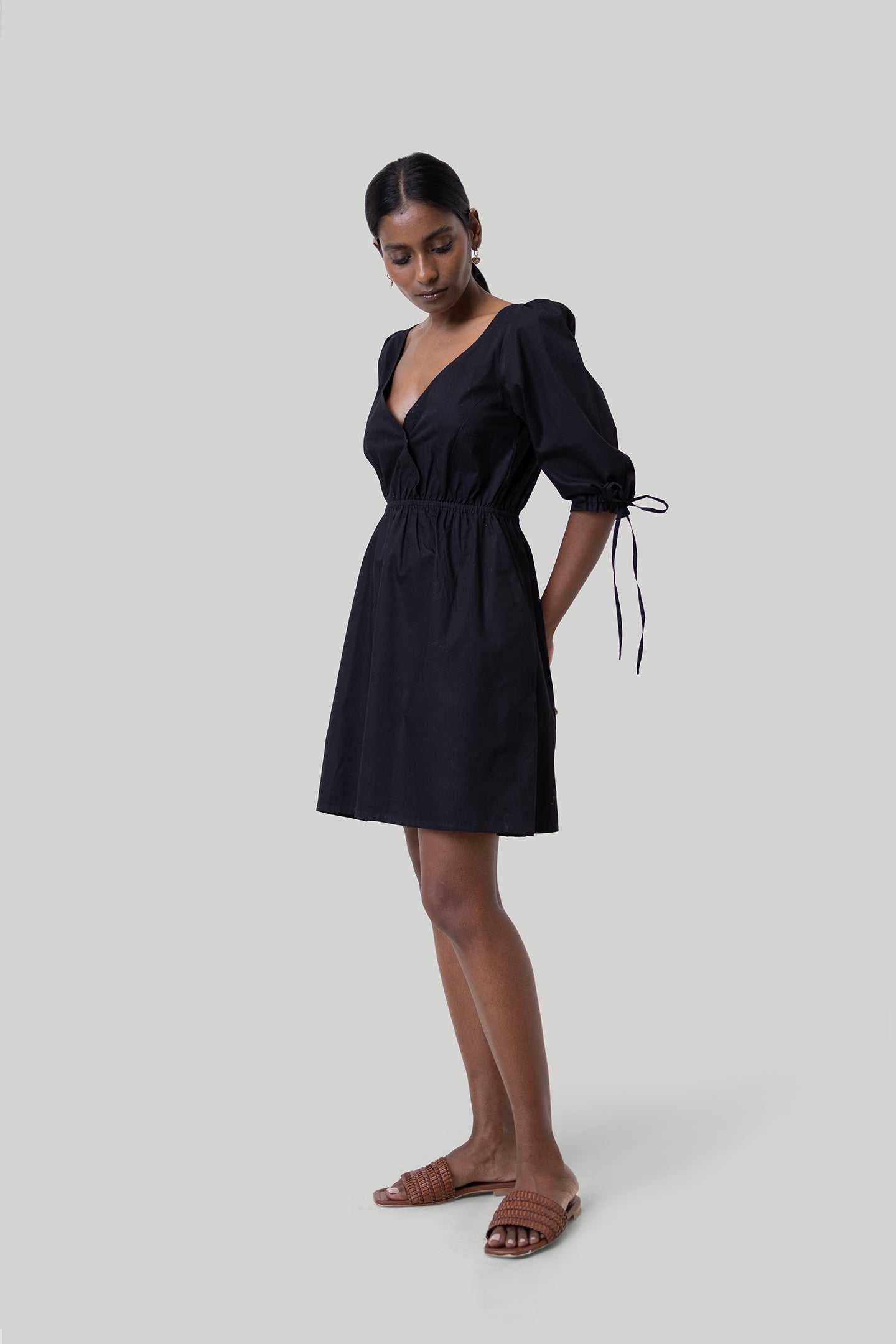 Black short dress with gathered elbow sleeves and bow ties, V-neck bodice