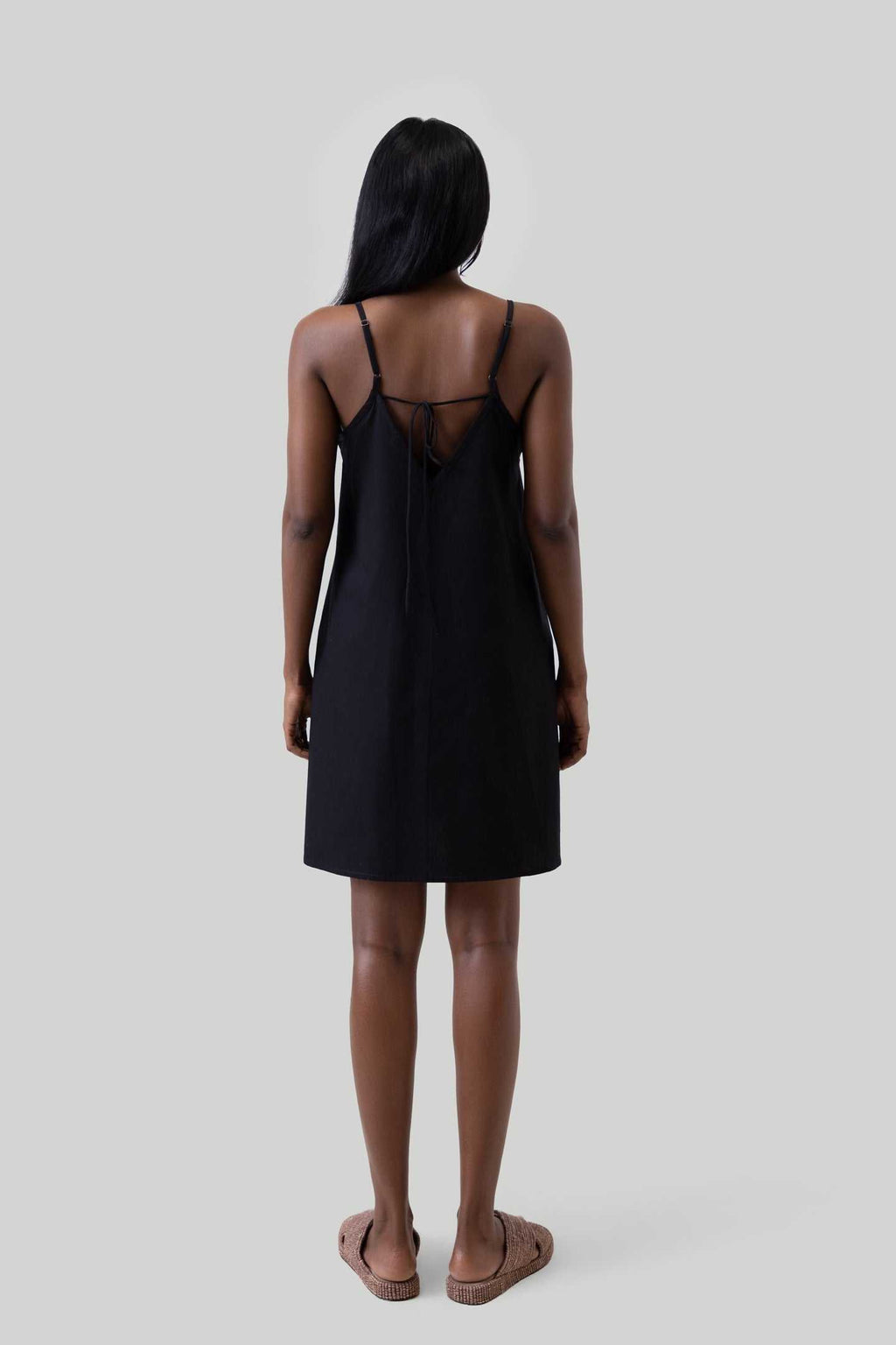 Black short tent dress back view with crisscross straps and tie detail