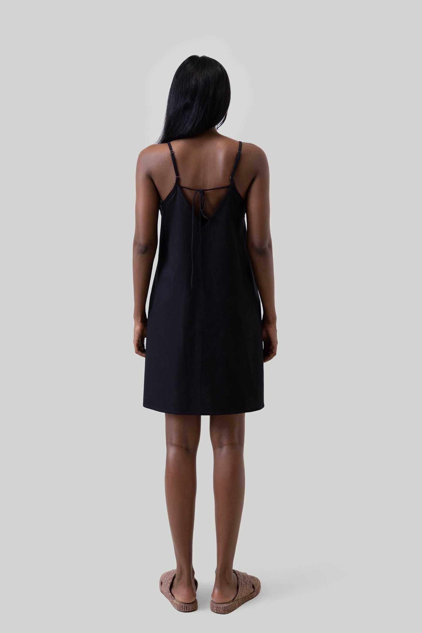 Black short tent dress back view with crisscross straps and tie detail