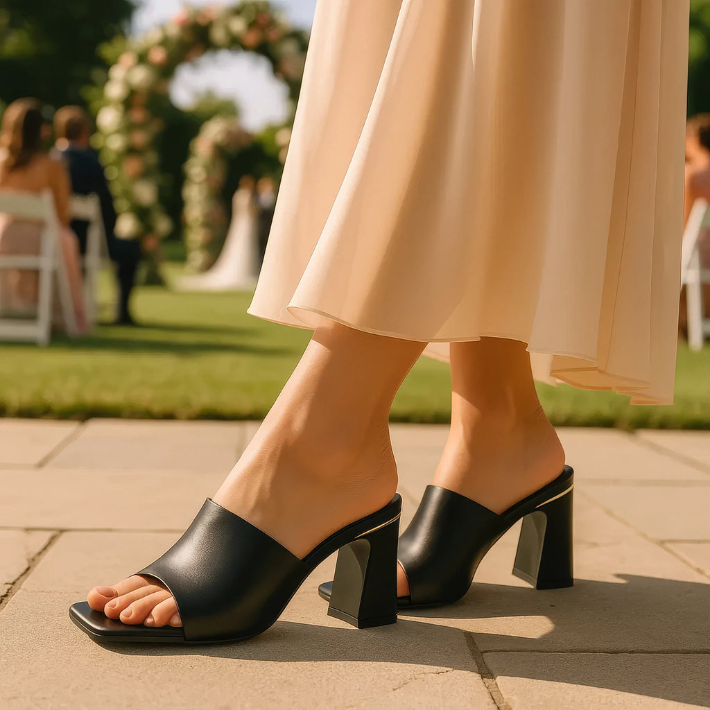 Black square-toe heeled slide sandals with wide strap and chunky block heel