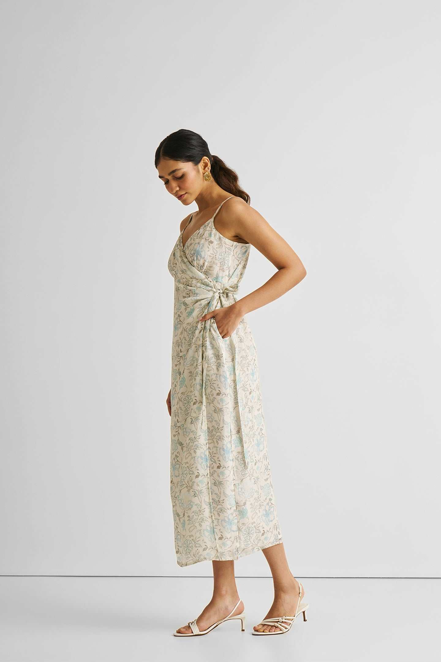 Blue floral wrap midi dress, side view with tied waist detail
