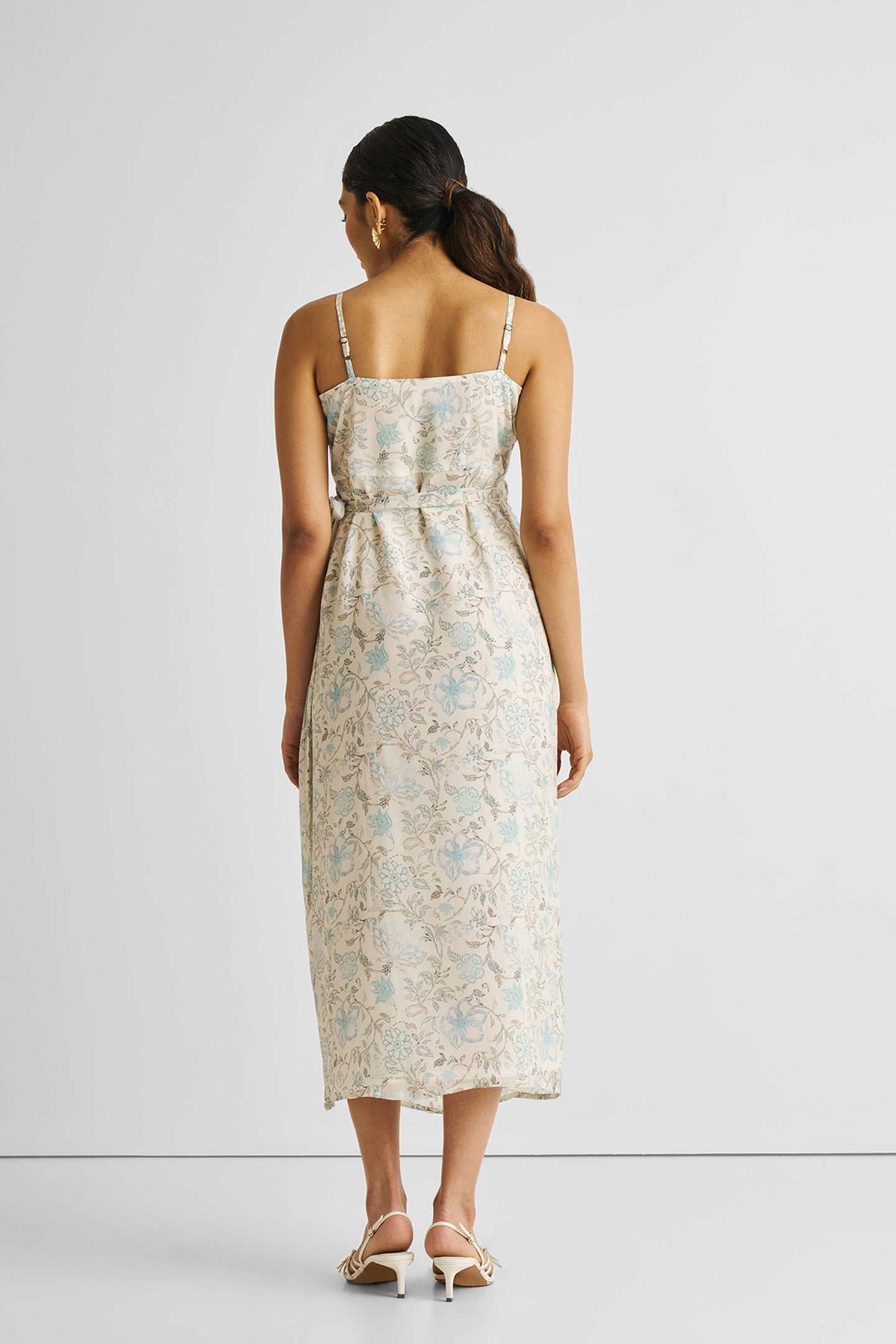 Back view: blue floral strappy wrap midi dress with square back