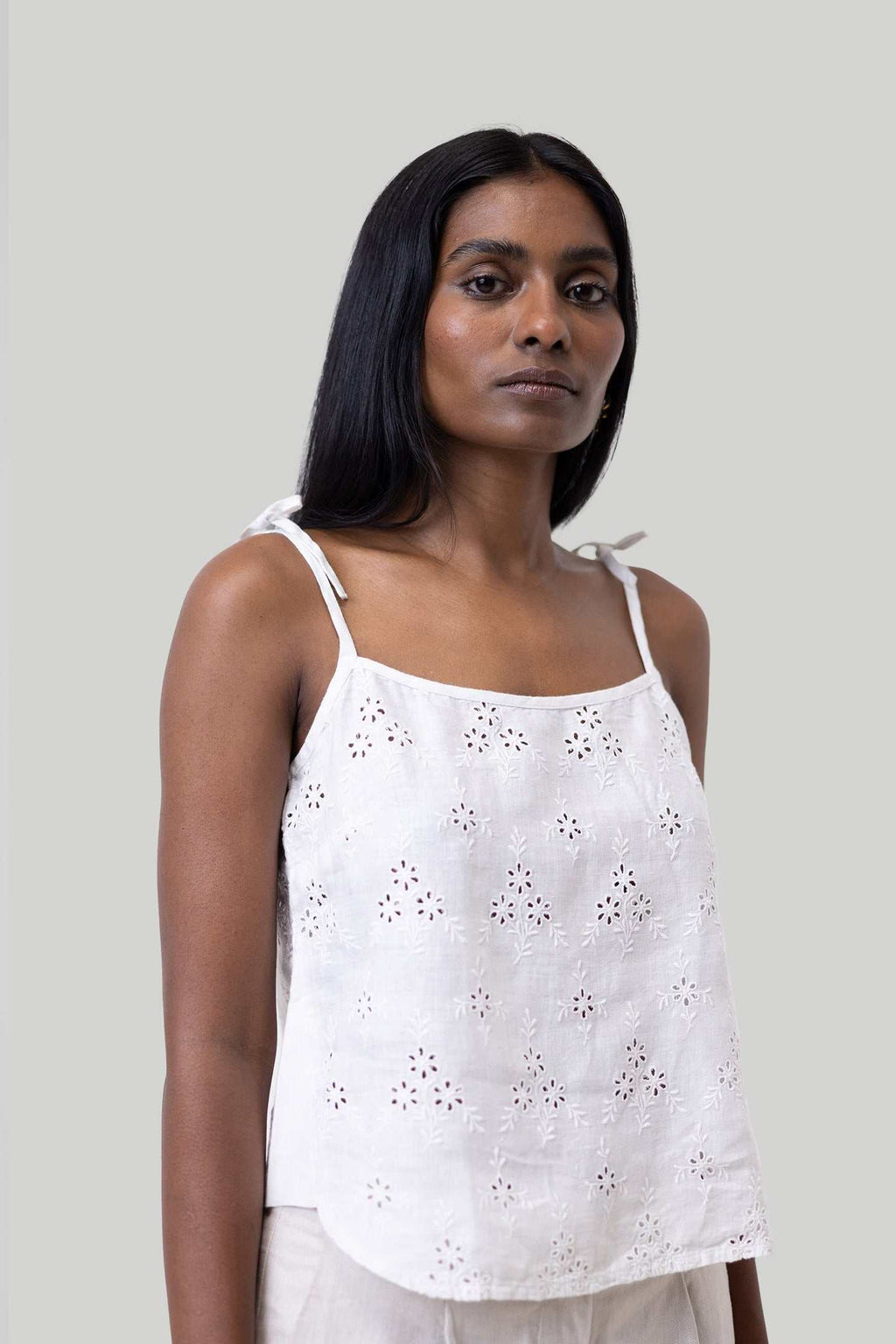 White tie-up camisole with eyelet embroidery and thin shoulder straps