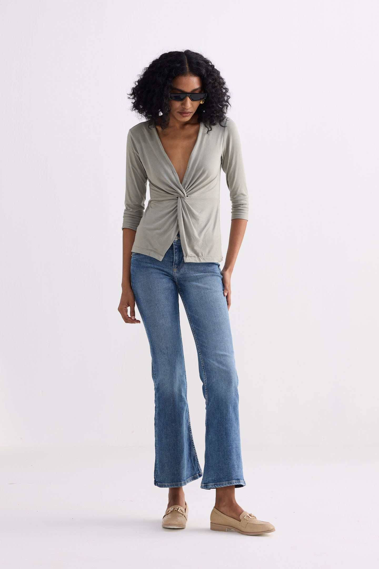 Light olive twist-front knit shirt from front angle, V-neck and 3/4 sleeves