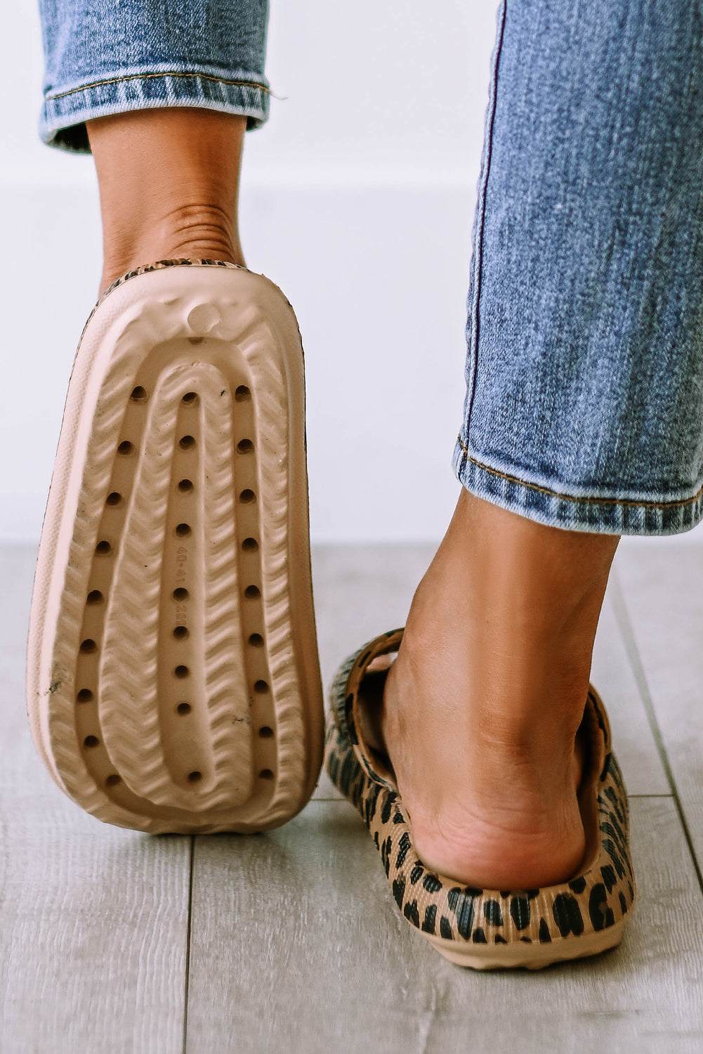 Leopard print slip-on slippers with ridged sole texture, side and footbed