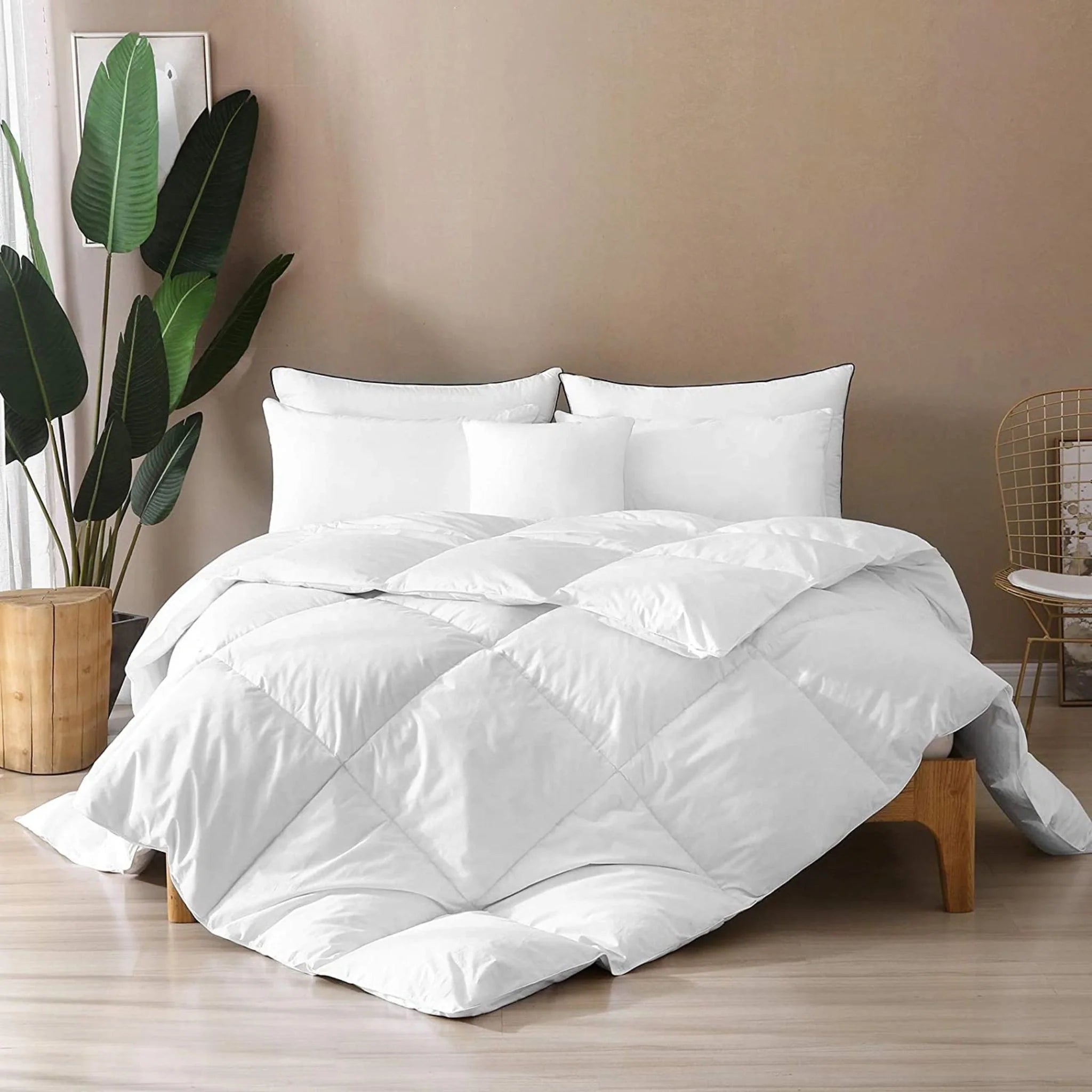 White duvet comforter draped on bed, diamond quilting and stitched baffles