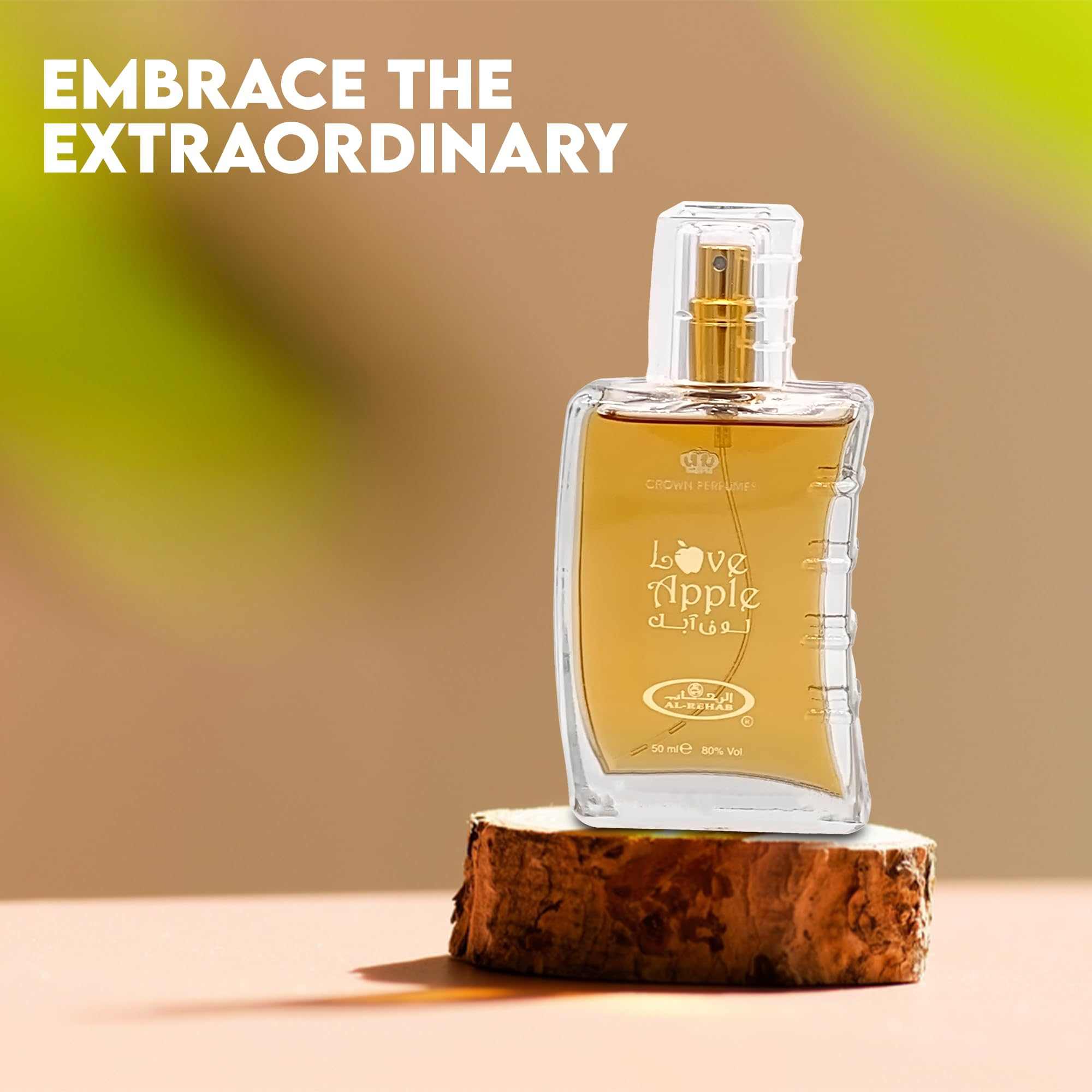 “Love Apple” perfume bottle with gold spray on a cut wood base