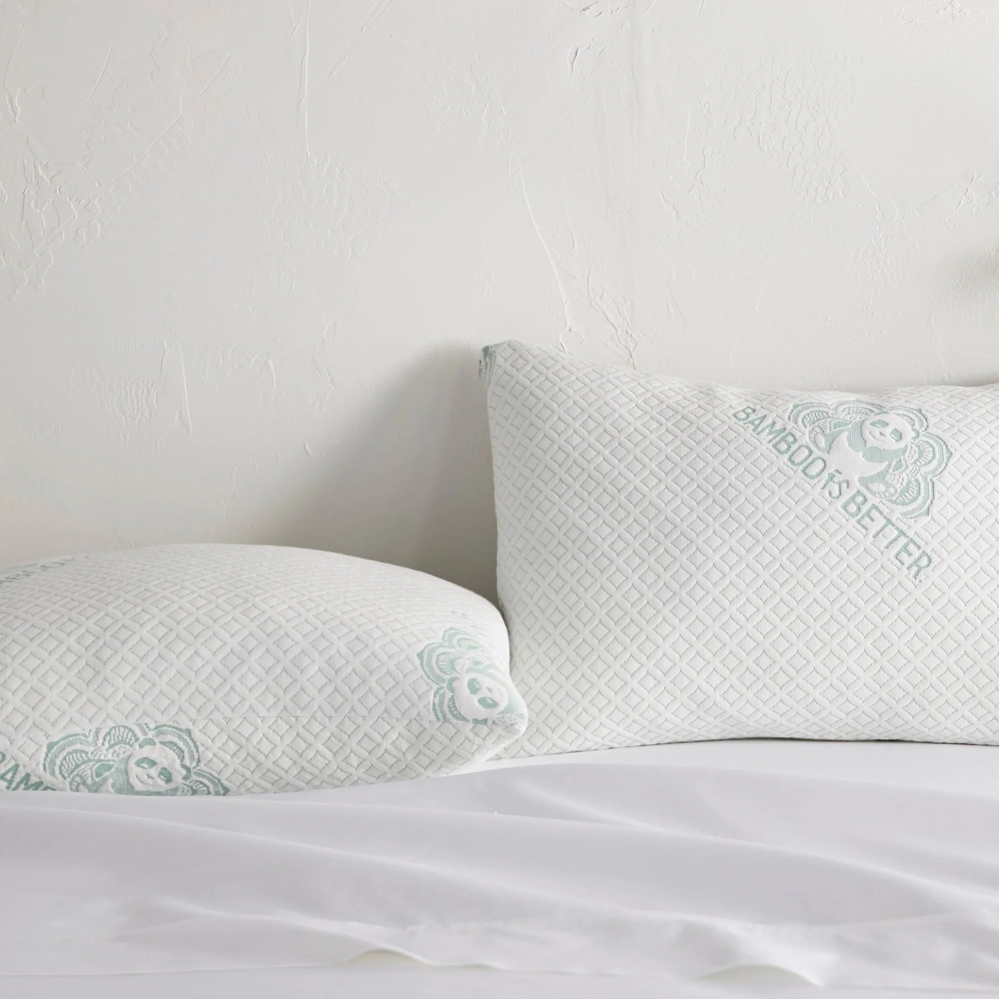 Adjustable bamboo cooling pillow with white cover and mint bear pattern on the front