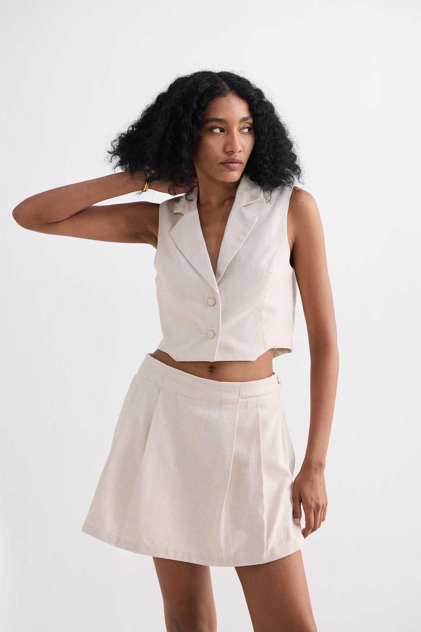 Cream cotton tweed skort with side pleat folds, front waistband and skirt flare