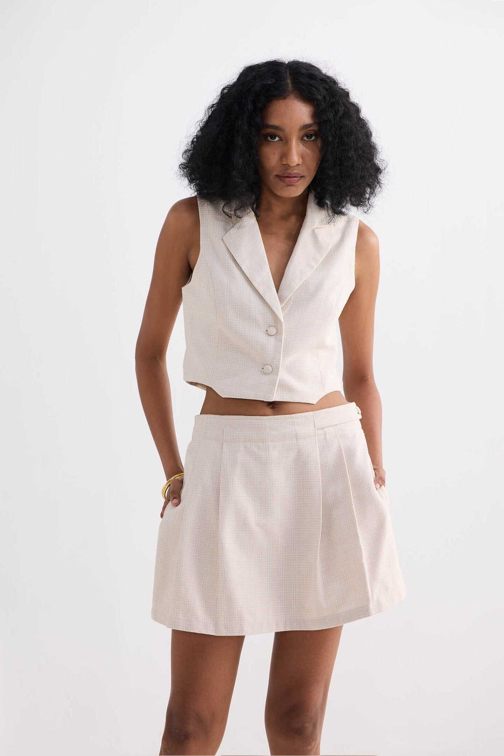 Cream cotton tweed skort, front view showing pleated skirt overlay and waistband