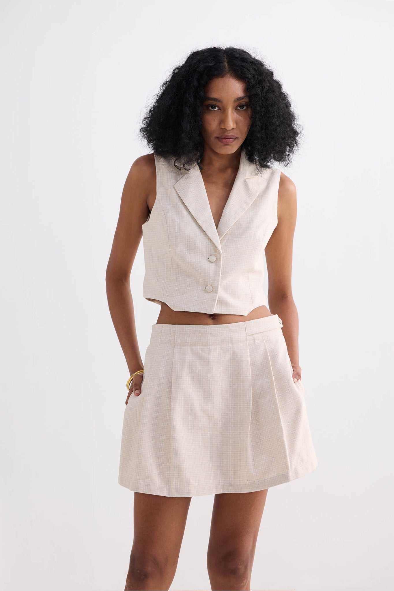 Cream cotton tweed skort, front view showing pleated skirt overlay and waistband
