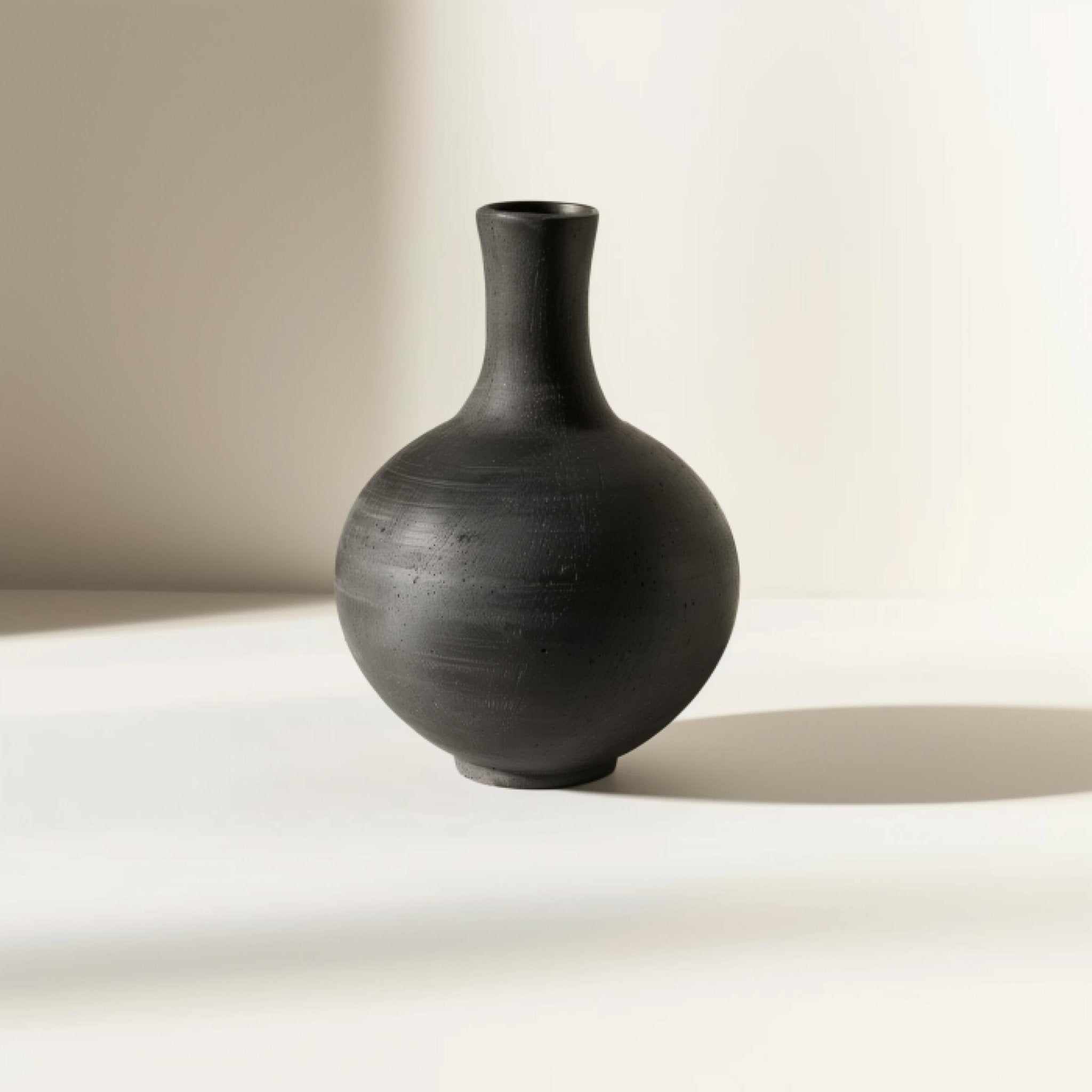 Example product: dark ceramic vase with narrow neck and round body
