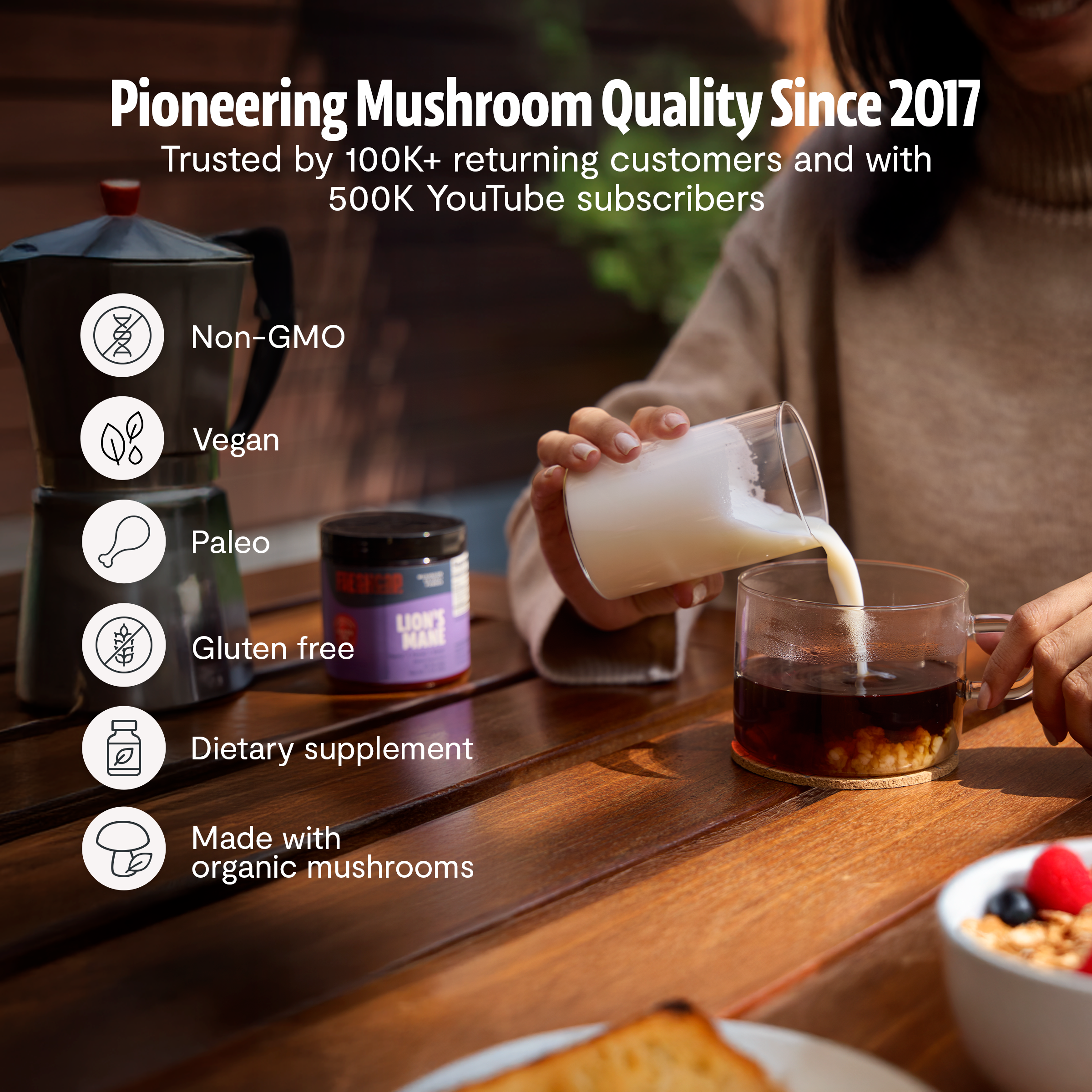 Ultimate Mushroom Complex supplement bottle on table, with pouring drink in hand