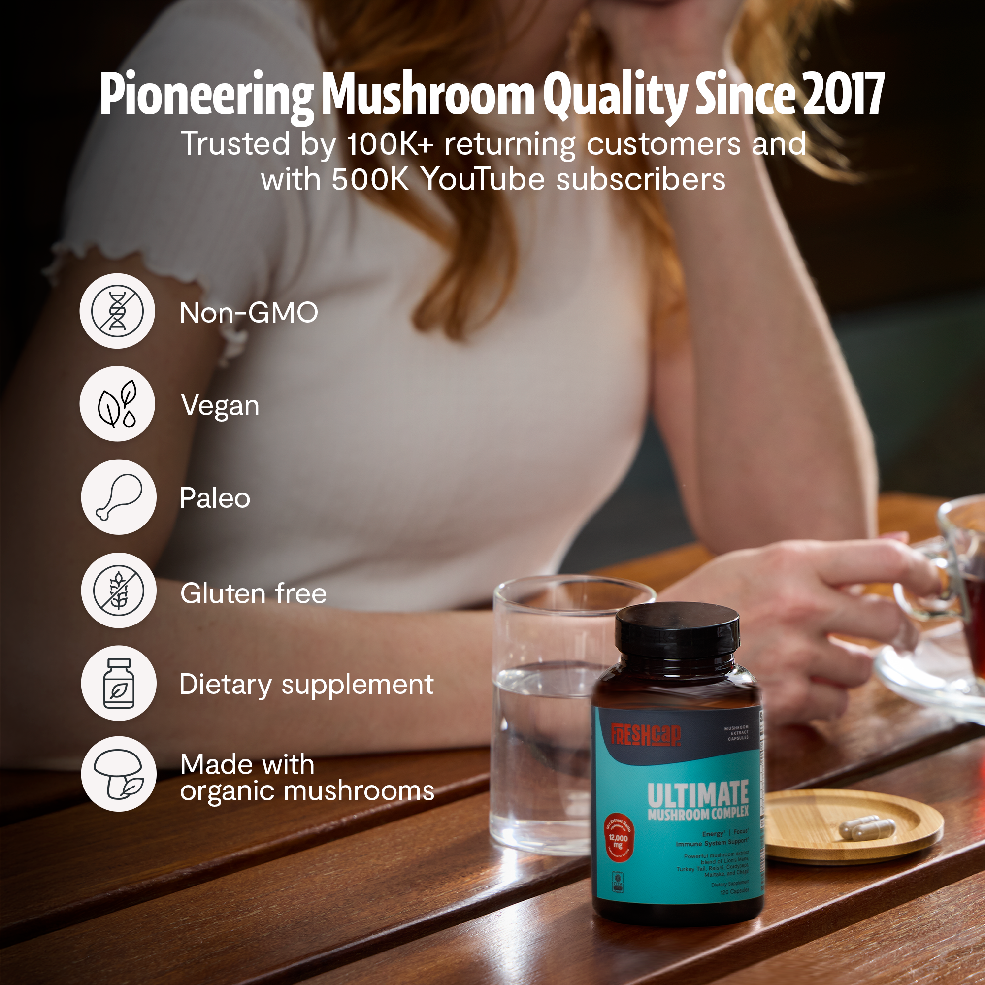Ultimate Mushroom Complex bottle on table with drinking glass and nutrition badges
