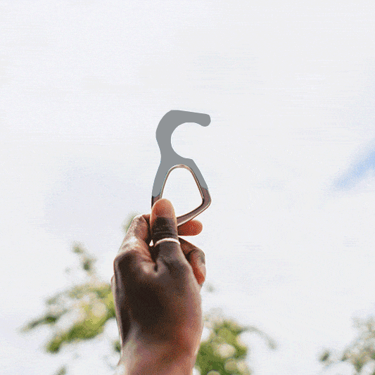 Cool gray silicone no-touch keychain tool with metal key ring in hand