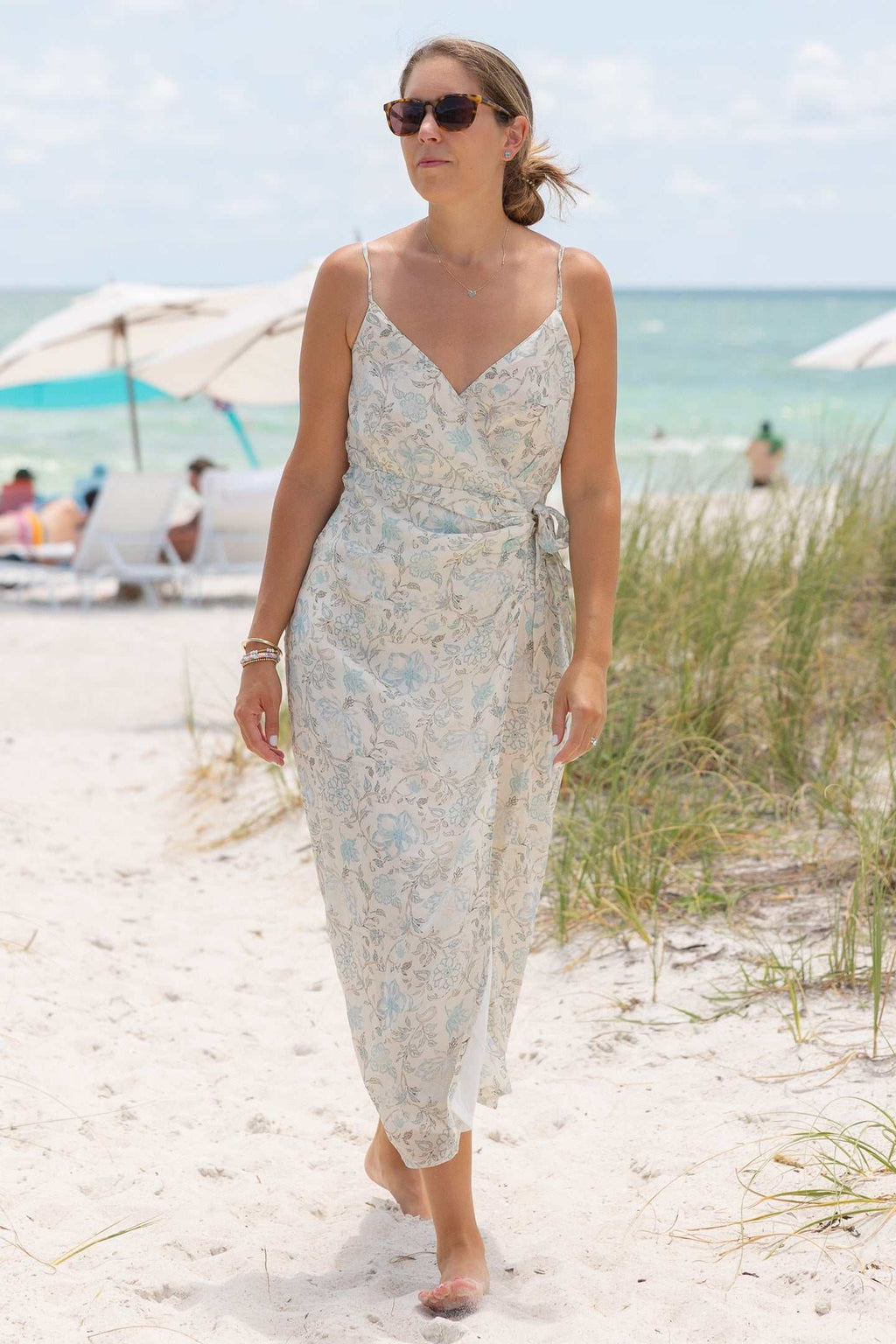 Blue floral wrap midi dress with thin straps and V-neck front
