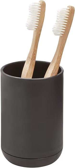 Matte black toothbrush holder with two wooden-handled brushes