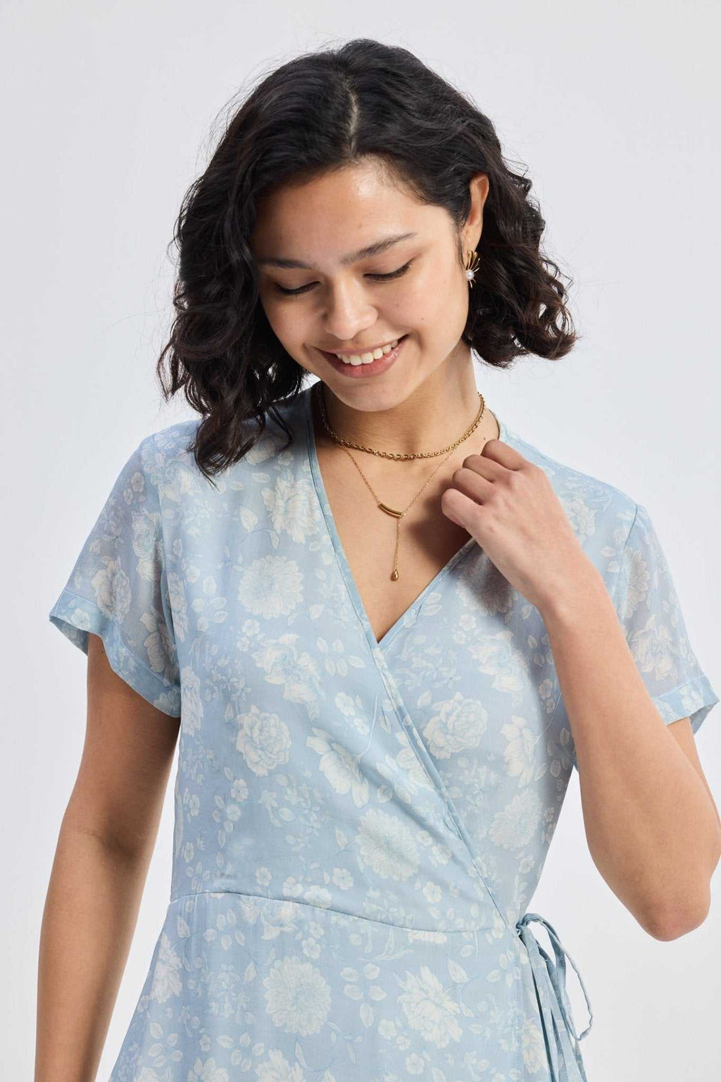 Wrap front bodice of the light-blue floral maxi dress with V-neck and waist tie