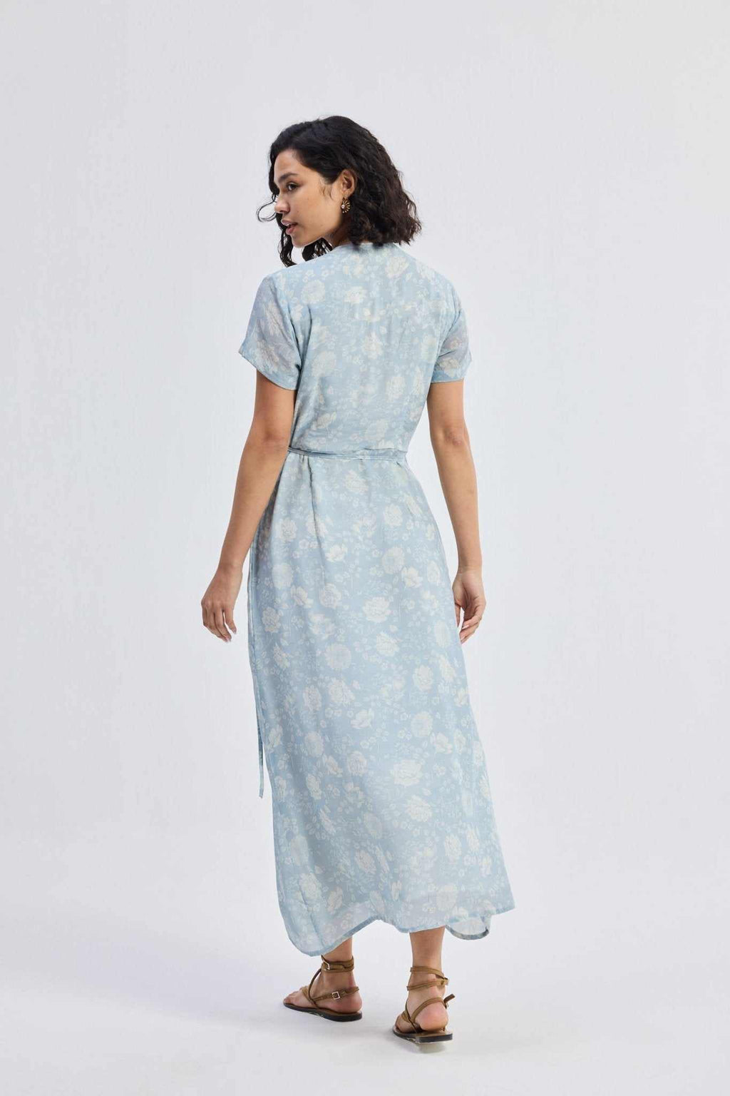 Back view of light-blue floral maxi wrap dress with short sleeves and tied waist