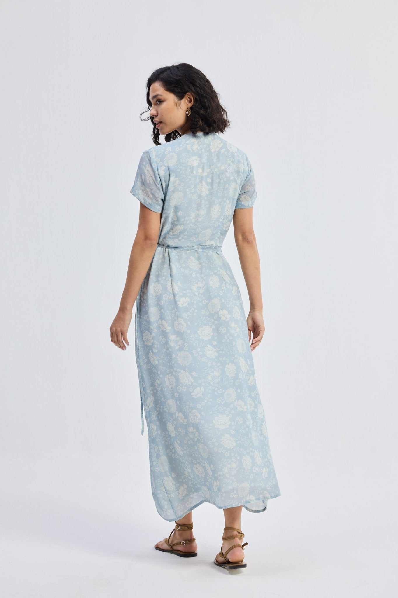 Back view of light-blue floral maxi wrap dress with short sleeves and tied waist
