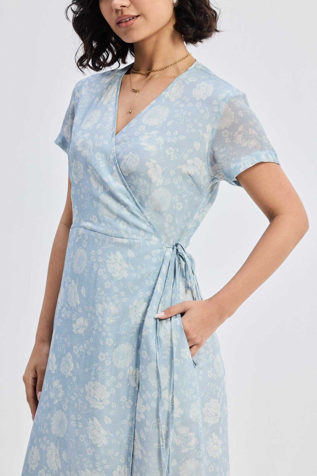 Light-blue floral maxi dress with tied waist sash and gathered wrap skirt front