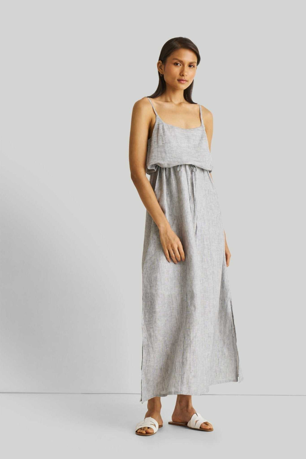 Strappy pinstriped maxi dress with spaghetti straps, waist ruffle, and long skirt