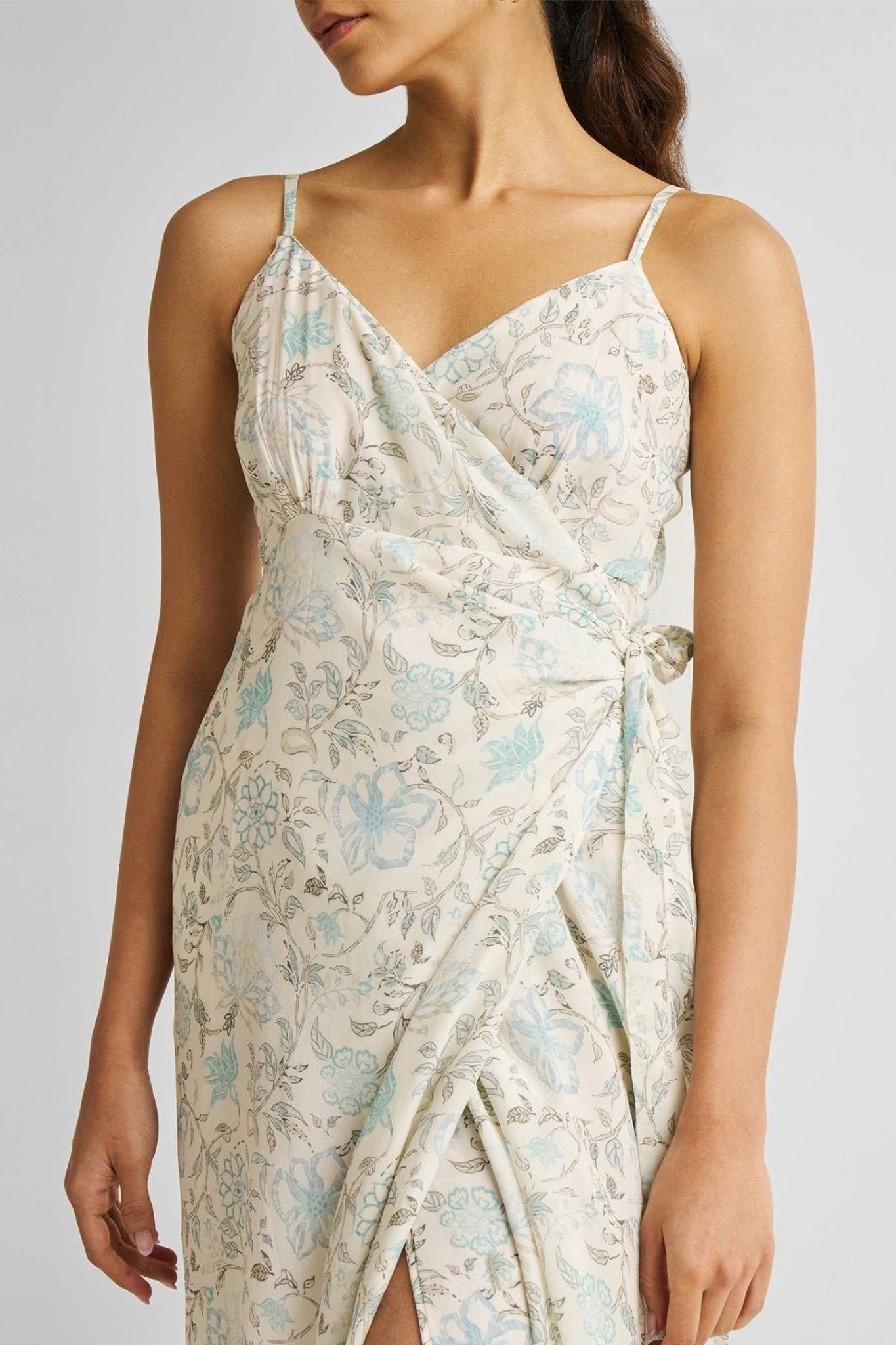 Front waist close-up: blue floral wrap midi with thin straps and side tie