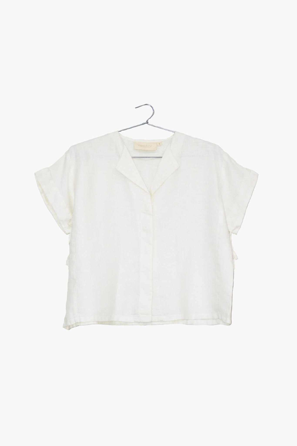 The Daydreams Shirt, shell off-white: cropped short-sleeve button-front blouse on hanger