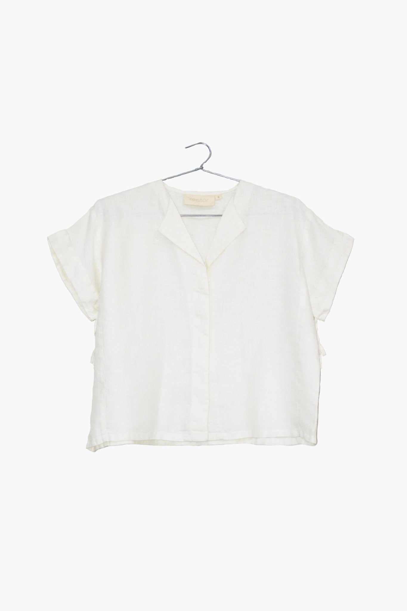 The Daydreams Shirt, shell off-white: cropped short-sleeve button-front blouse on hanger