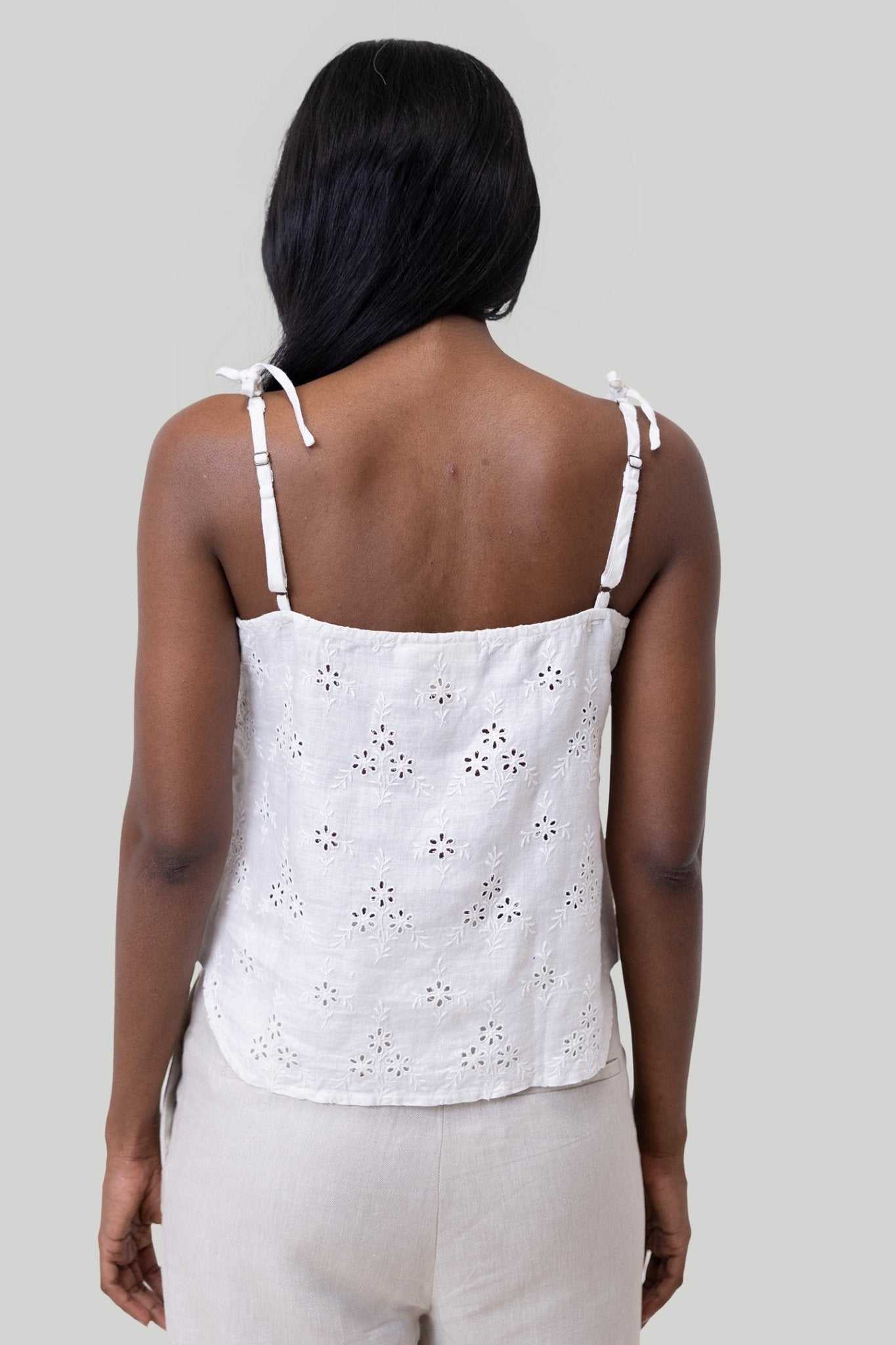 Back view of white tie-up camisole with shoulder ties and eyelet embroidered pattern