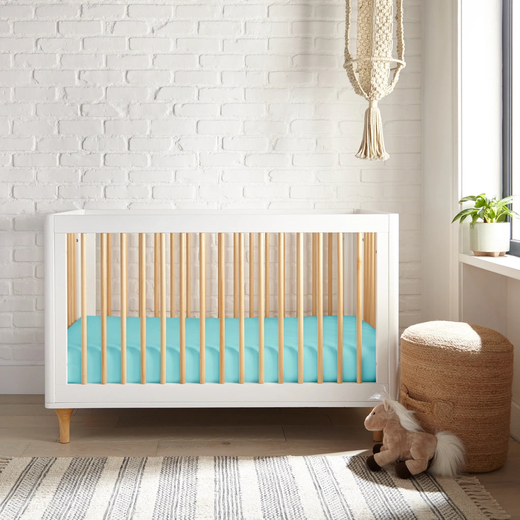 TIFFANY BLUE fitted sheet on crib mattress, snug elastic skirt at the edges.