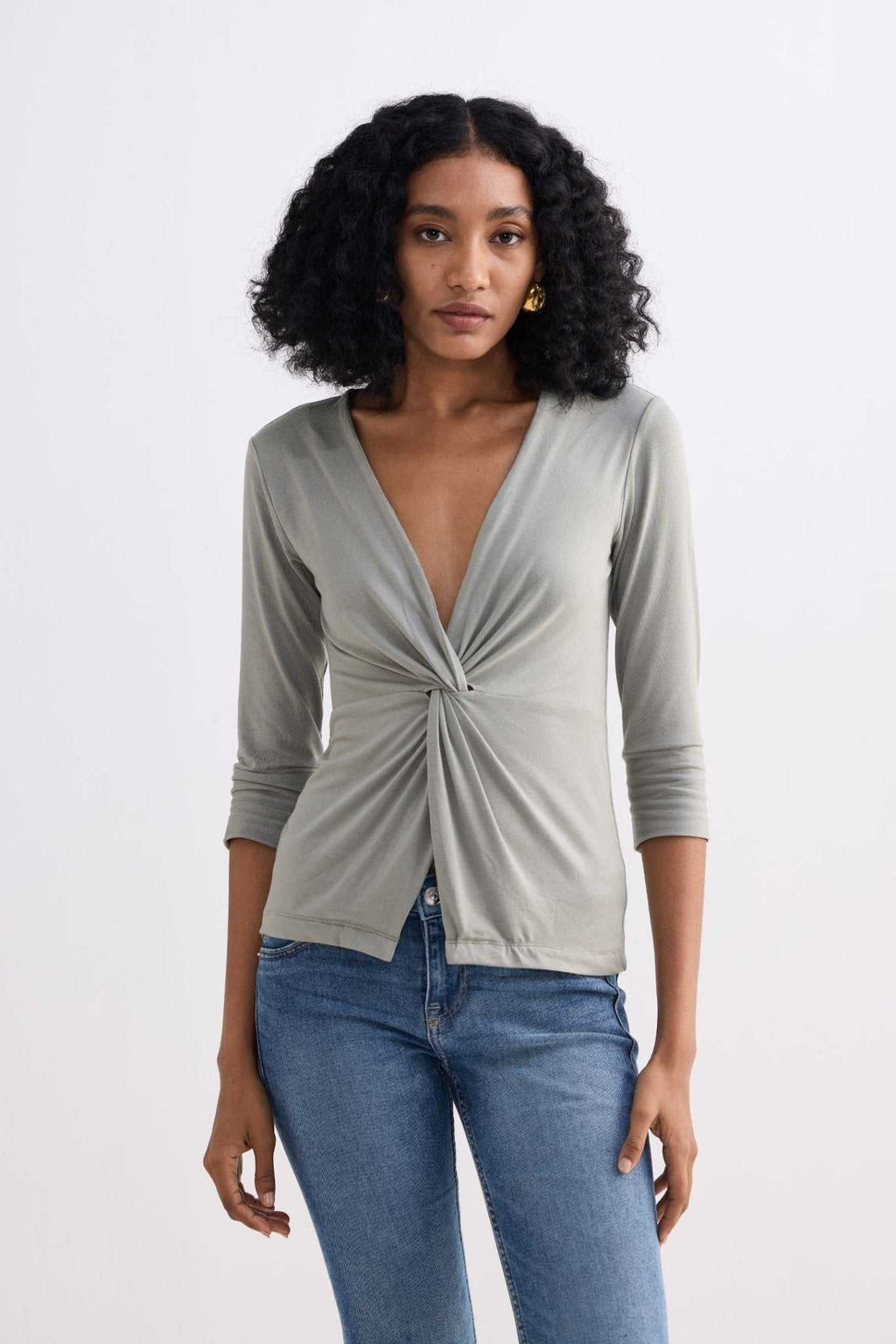 Light olive twist-front knit shirt with V-neck and three-quarter sleeves