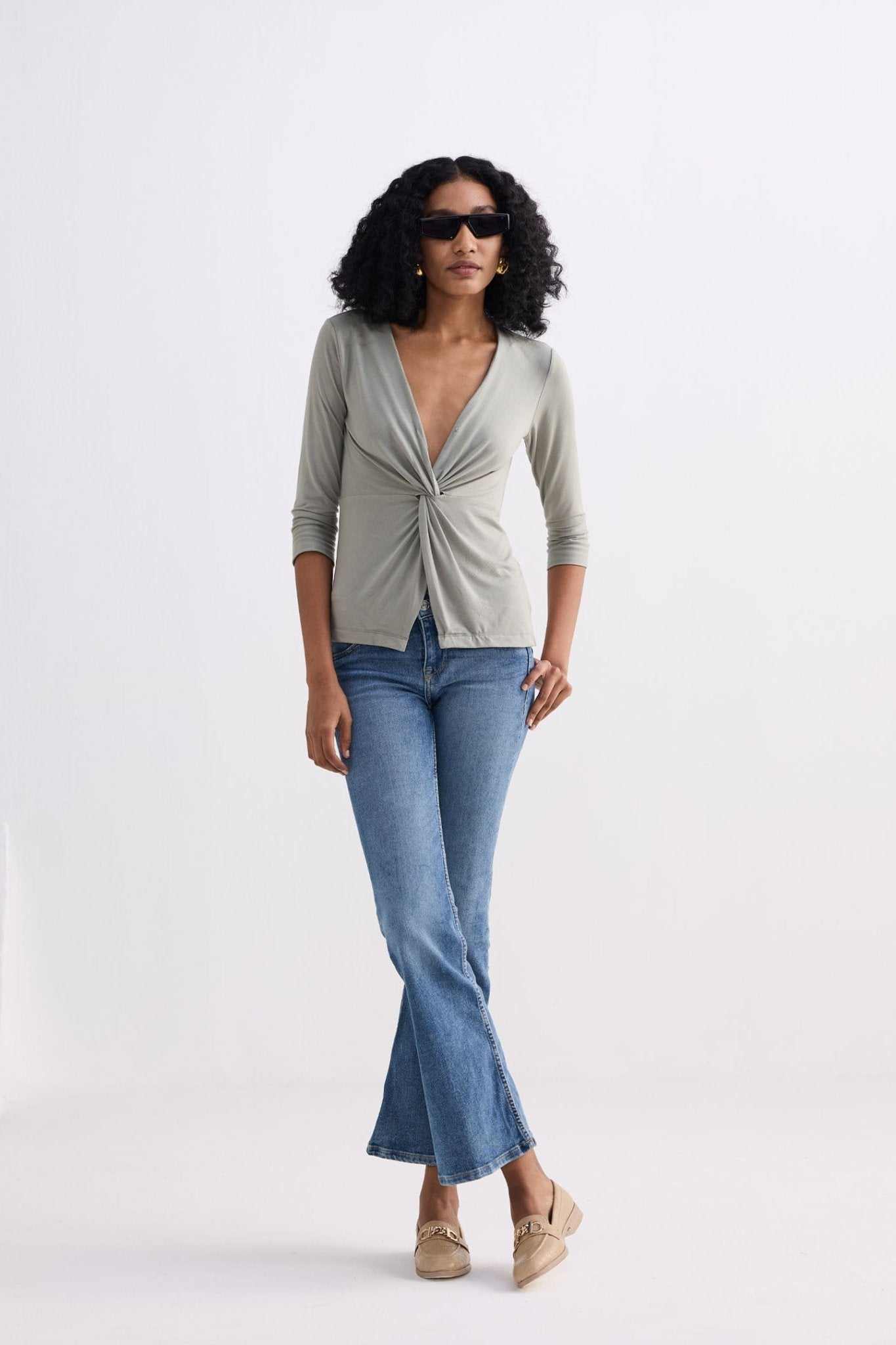Light olive twist-front knit shirt, V-neck, three-quarter sleeves on model