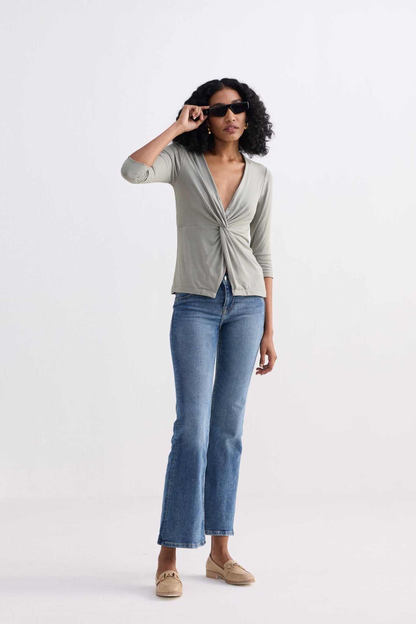 Light olive twist-front knit shirt with deep V-neck and knot detail