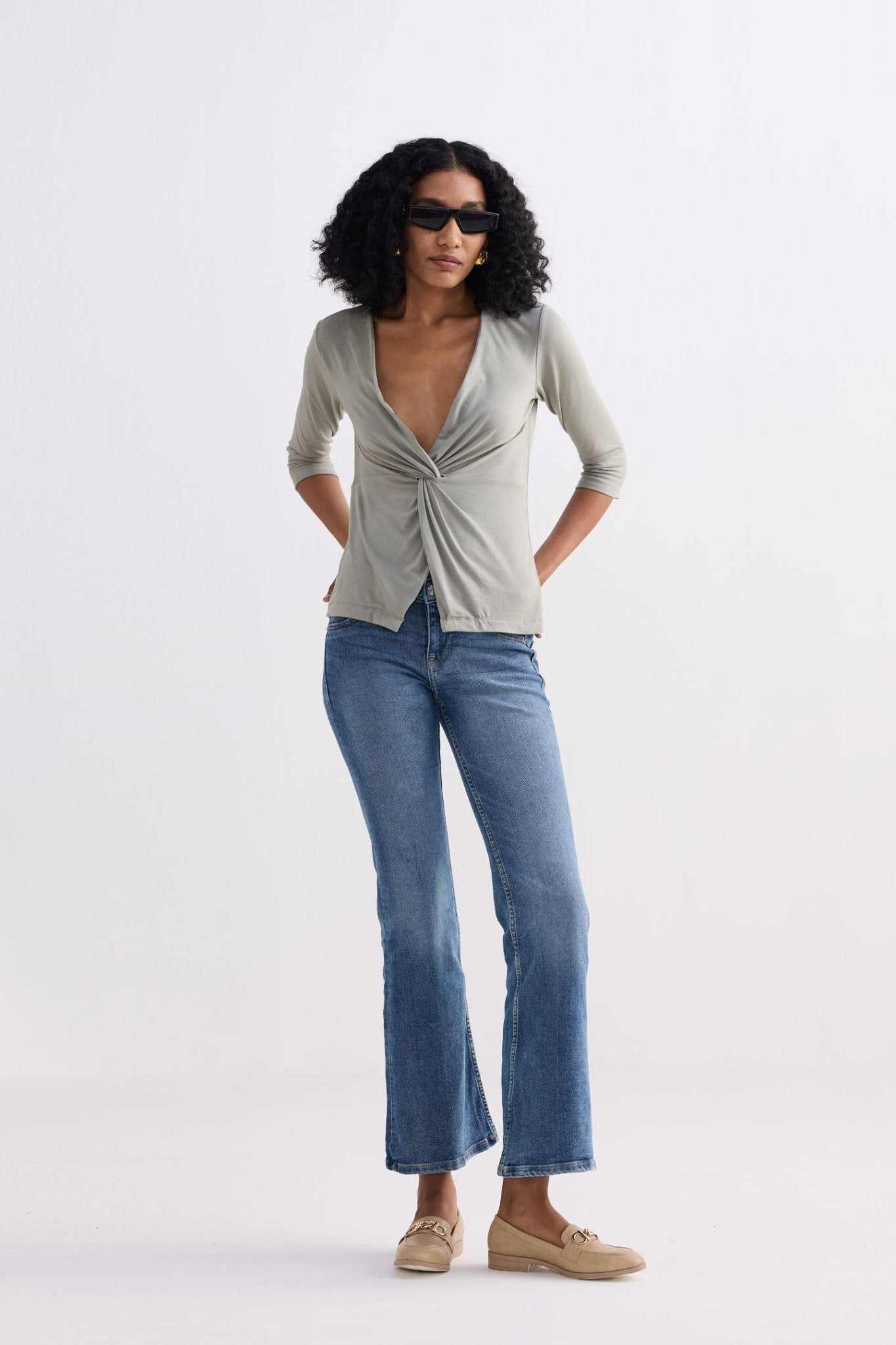 Light olive V-neck twist-front knit shirt with fitted drape