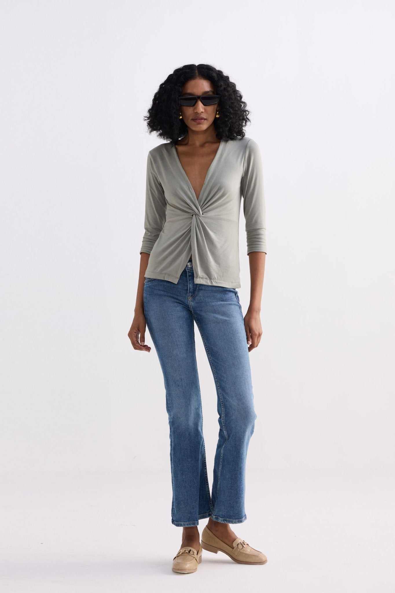 Light olive twist-front knit shirt, front view, three-quarter sleeves