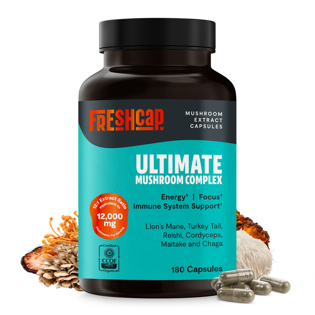 Close-up Ultimate Mushroom Complex bottle with teal label, mushroom mix and visible capsules.
